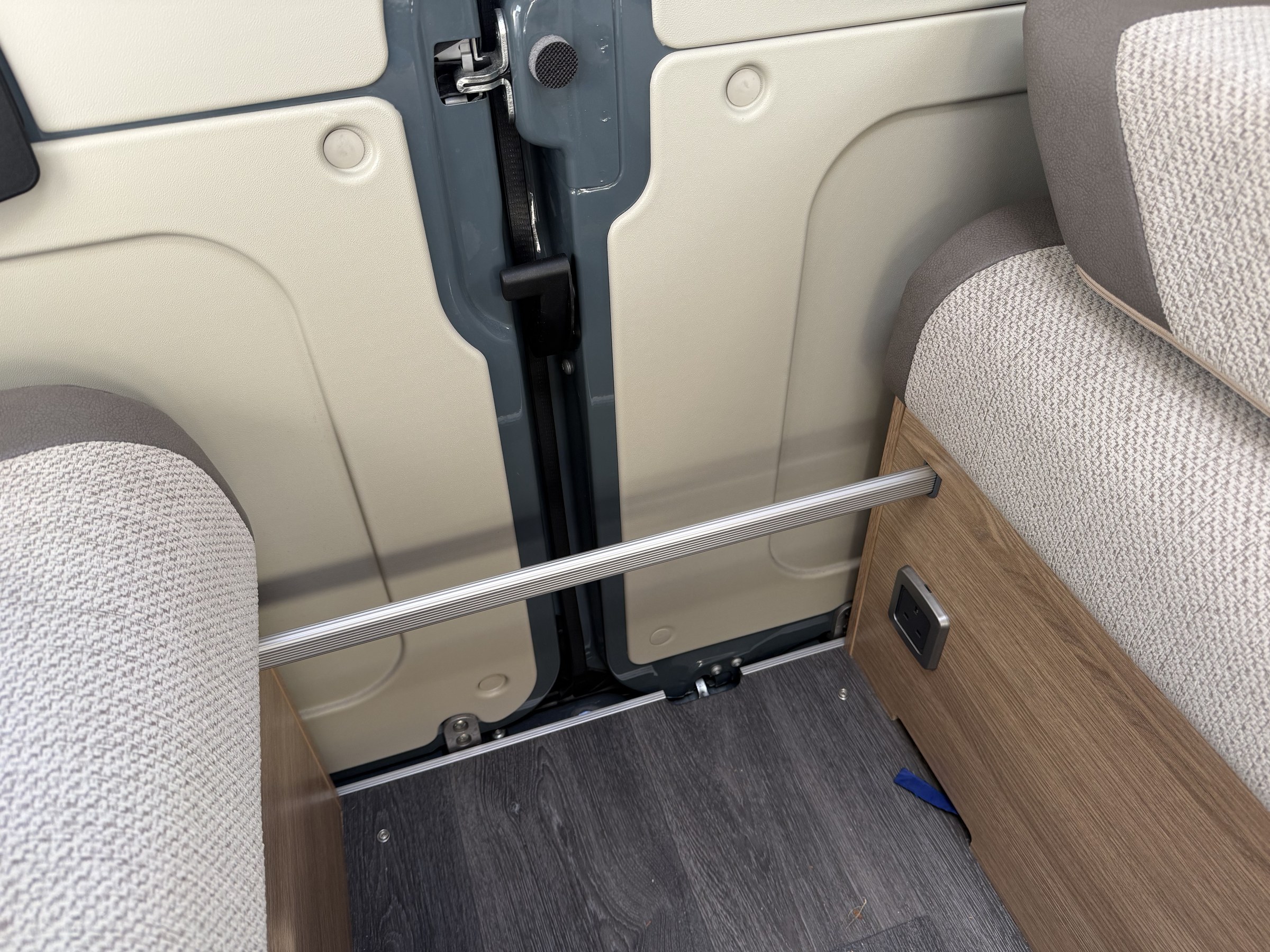 The crossbar fitted across the aisle to support the pull-out bed sections