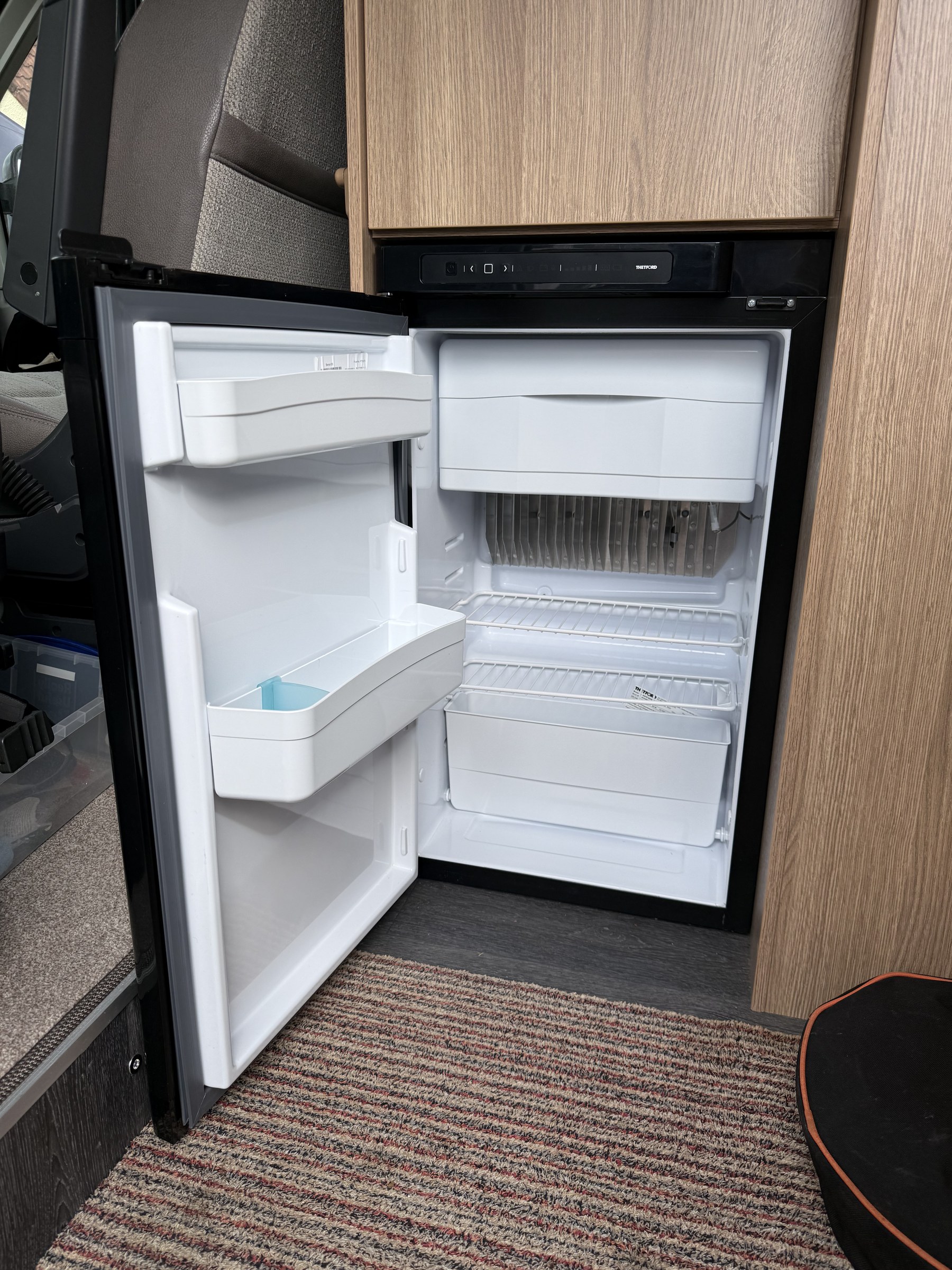 The inside of Ollie-II's fridge and its small freezer compartment