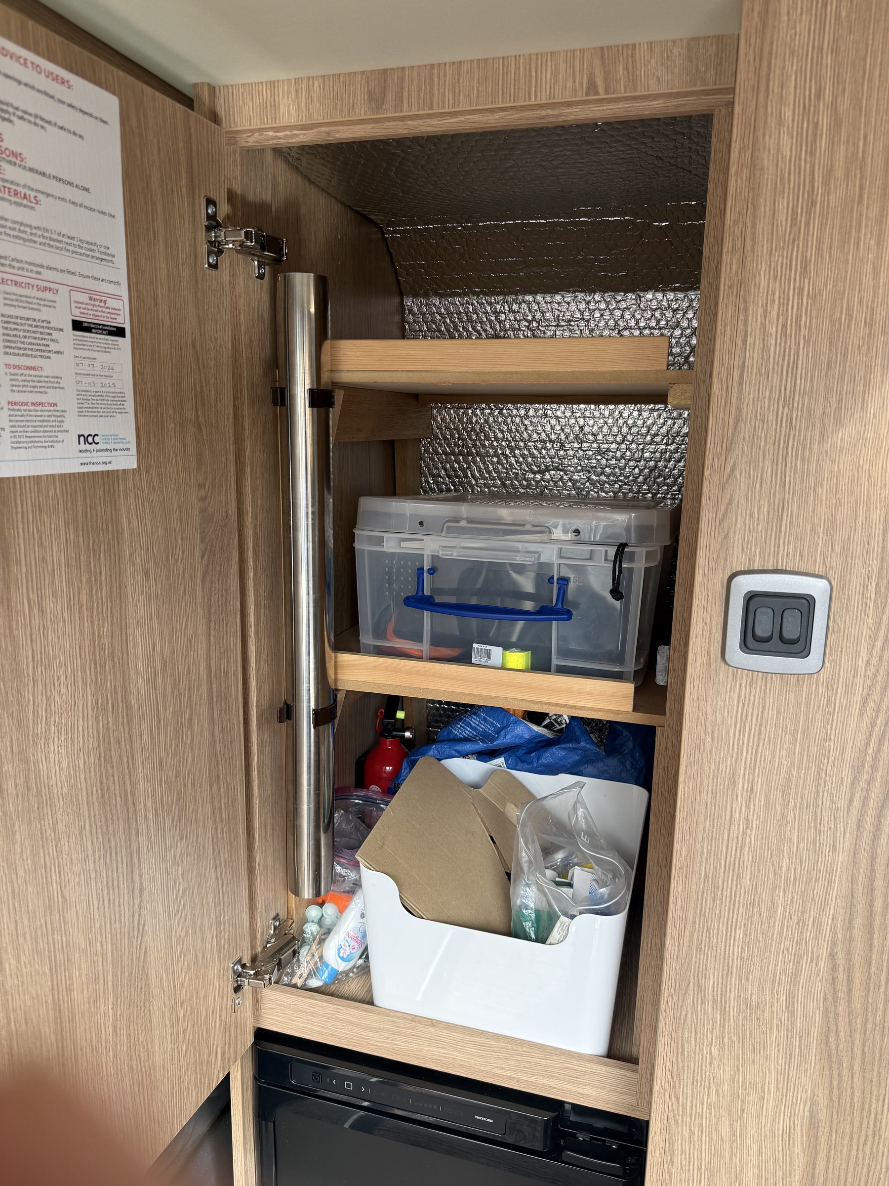The stainless-steel indoor-table leg stored in the cupboard above the fridge
