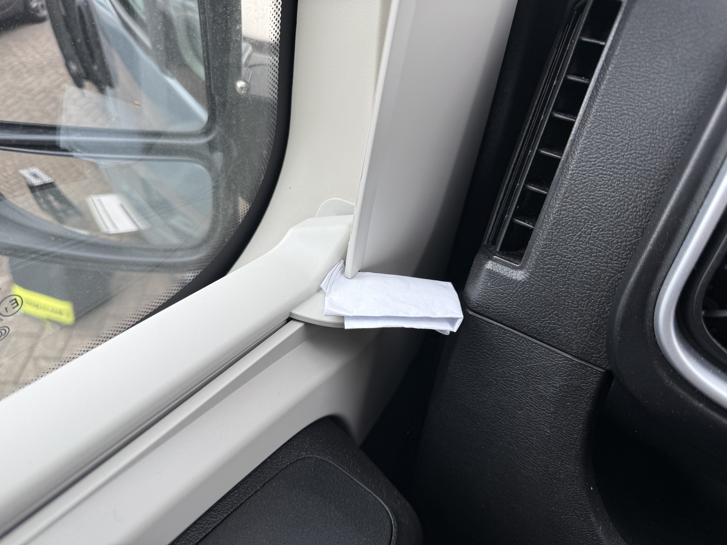 A wad of paper pushed into the side-window blind latch to stop it rattling