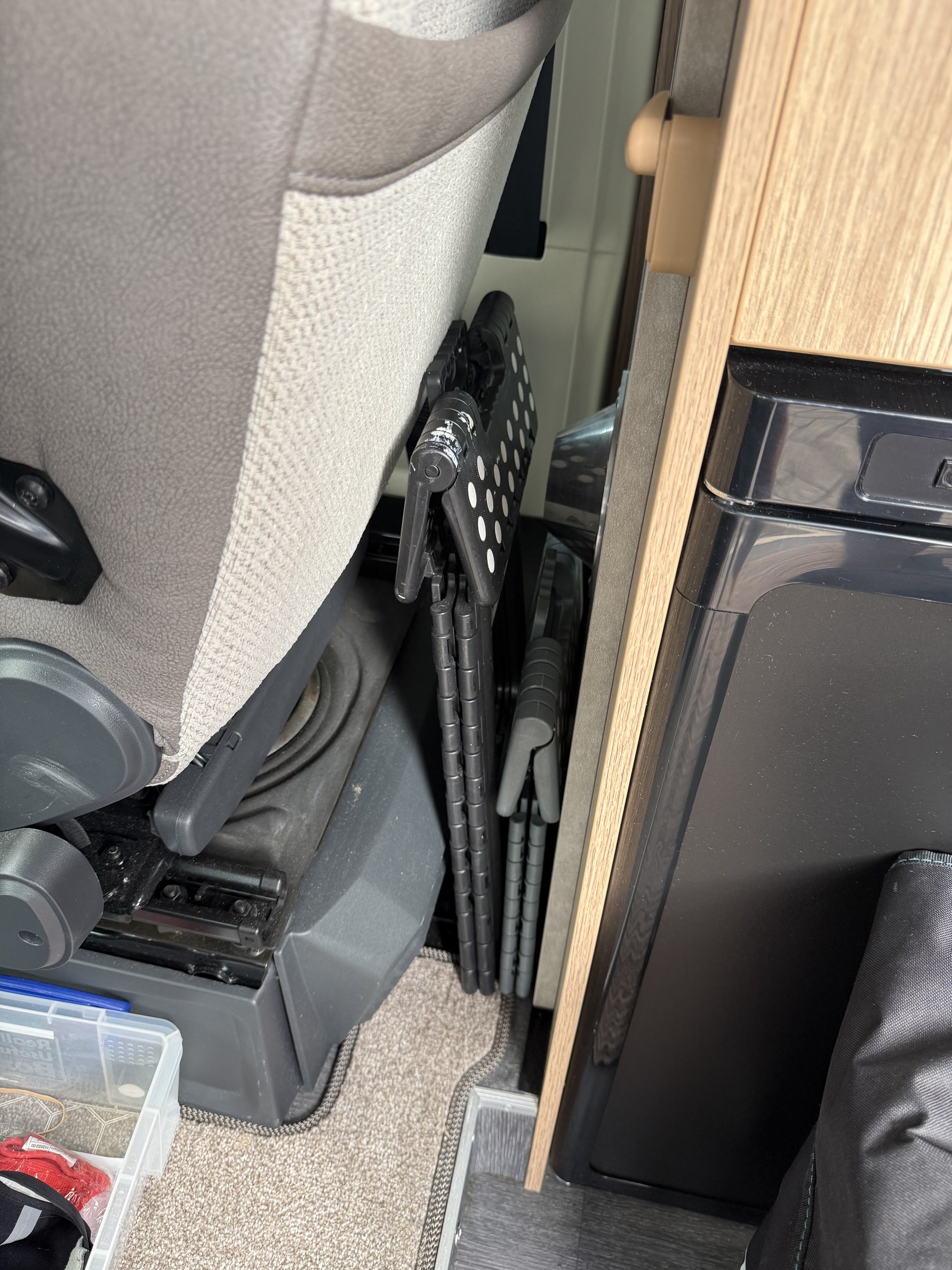 The short and tall folding stools packed behind the driver's seat