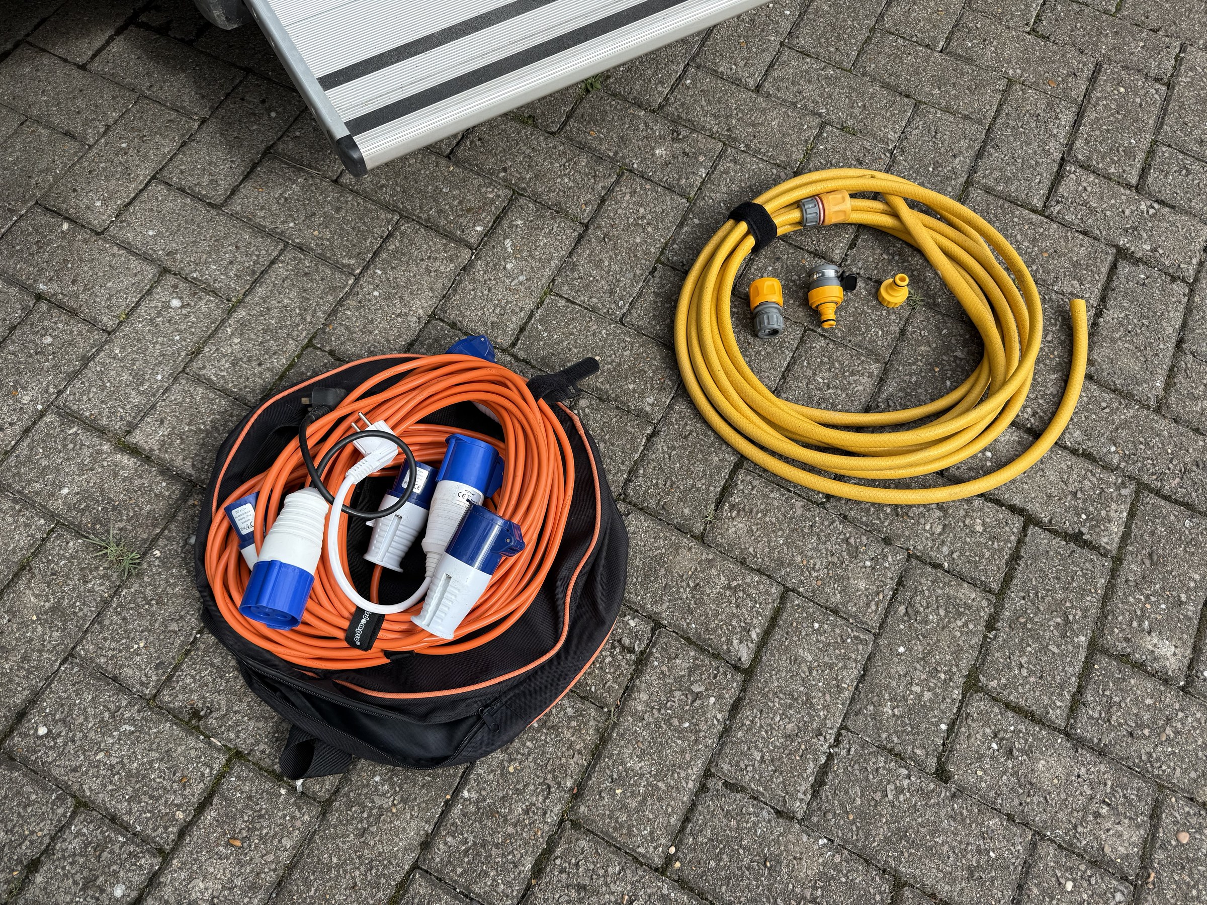 The fresh-water hose stored with the electric hook-up cable